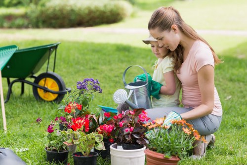 Professional using hedge trimmer in an urban garden